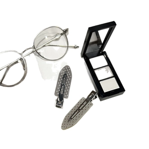 Polka dot sweet hair clips set in grey and light grey colors on a clean white surface