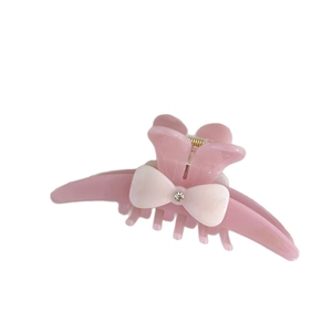 Elegant pink acetate shark hair claw clip with cream bow and rhinestone accent