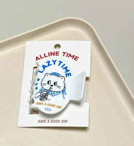 Detail view of white cat heart hair clip with sweet lazy time illustration and blue accents