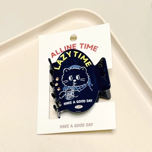 Detail of navy blue cat hair clip with rhinestones and lazy time print on card