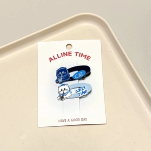 Detail of two-piece cat and heart hair clips set in navy and light blue on display card