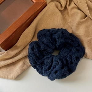 Navy blue crochet scrunchie with hollow knit texture for elegant hair styling