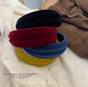 Close-up of colorful velvet headbands showing soft texture and thick padded design