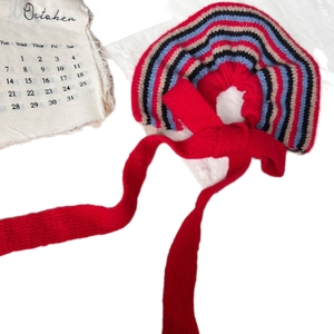 Retro red knit hair scrunchie with colorful striped pleated edges and long ribbons