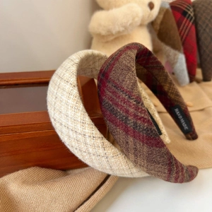 Close-up of wool plaid headband texture with hand-made label and soft sponge padding