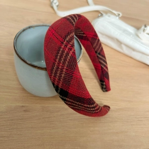 Detailed view of red plaid wool headband displayed on a ceramic mug for autumn styling