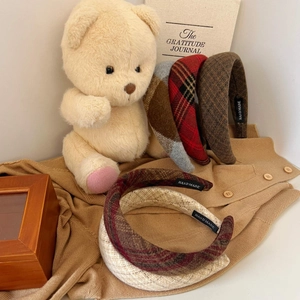 Detailed macro view of five vintage plaid wool headbands with handmade woven texture details
