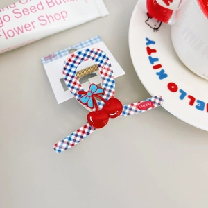 Sweet cherry hair claw with red and blue plaid pattern and light blue bow accessory