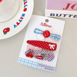 Detailed set of cherry bow hair clips including blue plaid and red polka dot styles