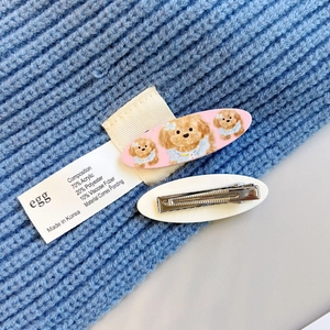 Detail showing pink teddy bear hair clip and back view of metal duckbill clip fastener