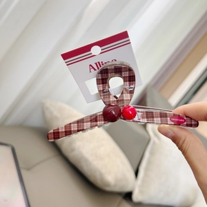 Detail of checkered hair claw clip with red beads and Sweet Love text on card