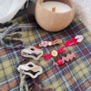 Detailed set of six red plaid hair clips with bow and heart motifs on vintage scarf