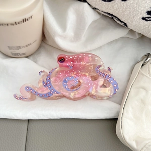 Cute pink octopus hair claw clip with white polka dots and stylish purple suction cup details