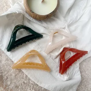 Detailed view of four 12cm geometric hollow hair claws in diverse glossy colors