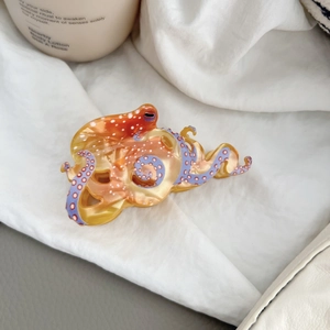 Detail of amber acetate octopus hair claw with purple tentacles and pink suction dots