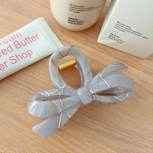 Elegant grey acetate bow hair claw clip with gold and silver marble texture for women