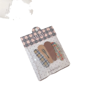 Set of four teardrop-shaped BB hair clips in plaid and solid colors on a card