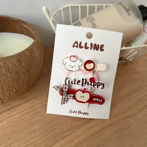 Detalle del set de pinzas para el cabello con diseño de perrito, manzana y lazos