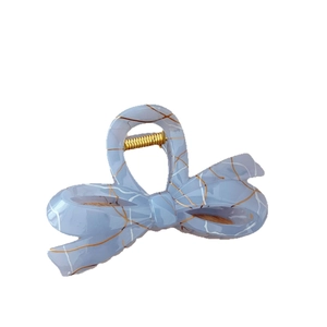 Elegant light blue acetate bow hair claw with gold marble patterns and metal spring