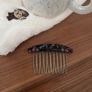 Detailed macro view of the handmade acetate hair comb with colorful polka dot texture