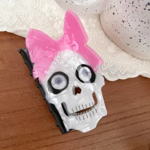 Unique skull hair clip with pink translucent bow and pearlescent white finish