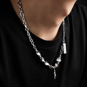 Punk style silver necklace with star pendant and textured metal tags on model