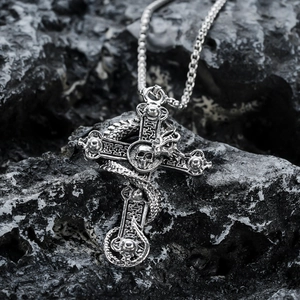 Gothic silver cross pendant with skull and dragon detailing on black stone background