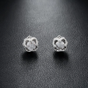 Silver magnetic flower stud earrings with crystal heart base on black leather