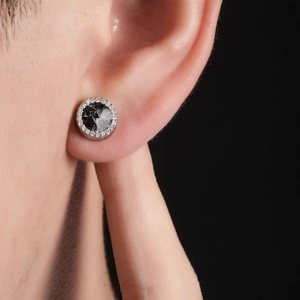 Gros plan d'un clip d'oreille magnétique avec pierre noire et pavé de zircons étincelants