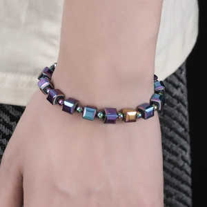 Macro shot of colorful magnetic hematite square bead bracelet worn on a wrist