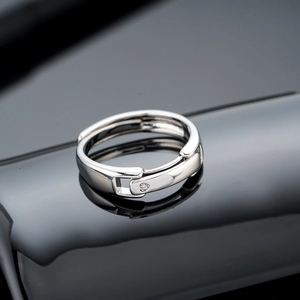 Adjustable silver belt buckle ring with heart-shaped diamond-cut cubic zirconia