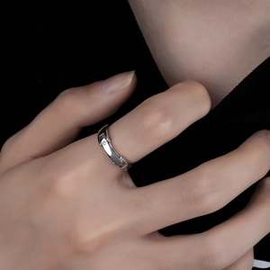 Minimalist silver geometric open ring with single zircon stone shown on a model's hand
