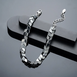 Macro shot of V-shaped hematite geometric links with lobster clasp and extension chain