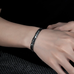 Macro detail of the polished black hematite chevron link bracelet for a sleek look