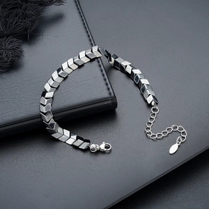 Minimalist V-shaped hematite bead bracelet with silver lobster clasp on black background