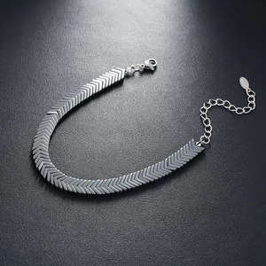 Close-up of matte black hematite arrow link bracelet with adjustable lobster clasp