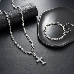 Icy silver cross pendant necklace and matching bracelet set with white zircon stones