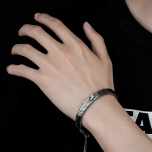 Men's silver V-shape link hematite bracelet with adjustable lobster clasp on wrist