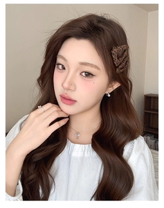 Close-up of leopard print hair clips and matching jewelry set worn by a female model