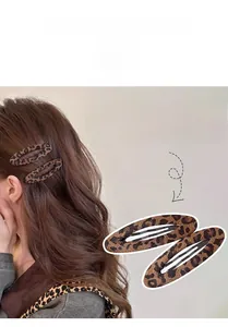 Detail of Korean style leopard print plush hair clips with soft fabric texture