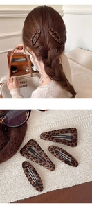 Detailed view of plush leopard print BB hair clips in teardrop and triangle shapes