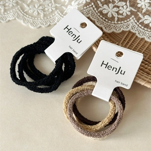 Close-up of seamless high-elasticity hair bands in black and brown tones on lace