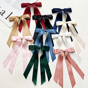 Elegant multi-color satin ribbon bow hair scrunchies displayed in a flat lay arrangement
