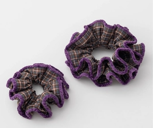 Detail of purple plaid fabric scrunchie with soft chenille trim for winter hair styling