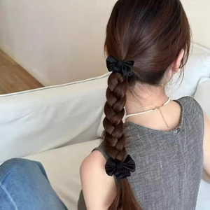 Elegant black satin double-layered bow hair scrunchies used on a braided hairstyle