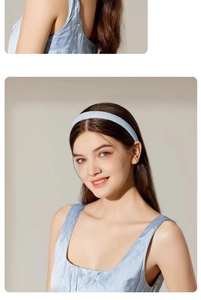 Detailed view of a sparkling light blue headband worn by a model in a sweet fashion style