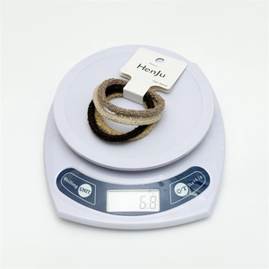 Minimalist high elasticity seamless hair ties set in neutral tones on weighing scale