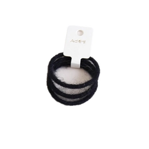 Set di tre elastici per capelli in peluche nero su cartoncino bianco per donne