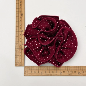 Deep burgundy polka dot scrunchie with 15cm diameter shown with a measuring ruler