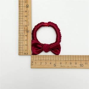 Elegant wine red bow hair scrunchie with silk texture and durable elastic tie for women
